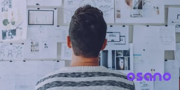 Data analyst looking at the board with the plan for implementing privacy by design