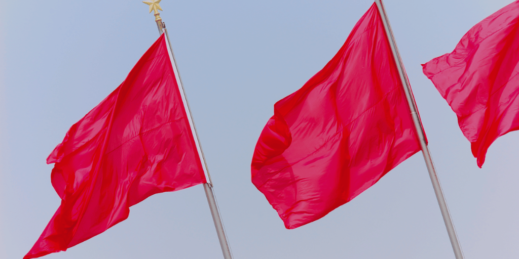 red flags waving in the sky